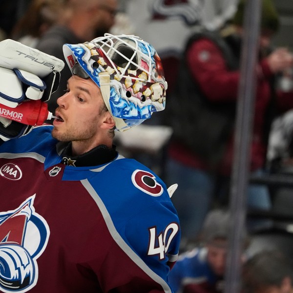 Colorado Avalanche goaltender Alexandar Georgiev drinks during a timeout in the second period of an NHL hockey game against the Anaheim Ducks, Friday, Oct. 18, 2024, in Denver. (AP Photo/David Zalubowski)