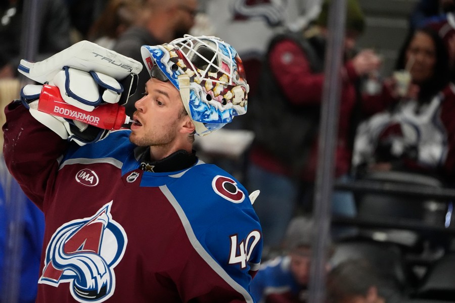 Colorado Avalanche goaltender Alexandar Georgiev drinks during a timeout in the second period of an NHL hockey game against the Anaheim Ducks, Friday, Oct. 18, 2024, in Denver. (AP Photo/David Zalubowski)