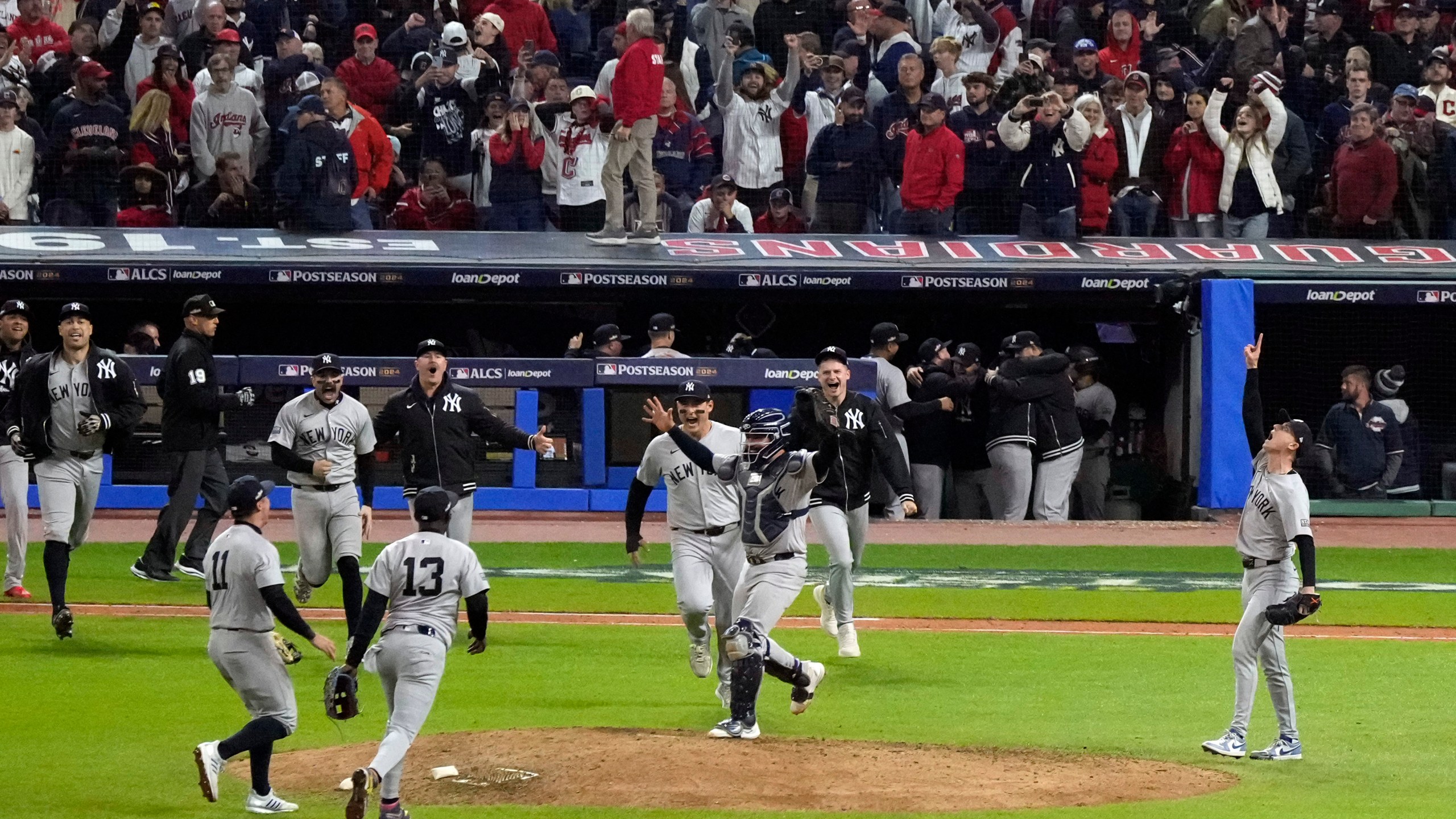 New York Yankees players celebrate after Game 5 of the baseball AL Championship Series against the Cleveland Guardians Saturday, Oct. 19, 2024, in Cleveland. The Yankees won 5-2 to advance to the World Series. (AP Photo/Jeff Roberson)