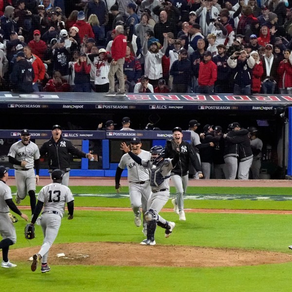 New York Yankees players celebrate after Game 5 of the baseball AL Championship Series against the Cleveland Guardians Saturday, Oct. 19, 2024, in Cleveland. The Yankees won 5-2 to advance to the World Series. (AP Photo/Jeff Roberson)