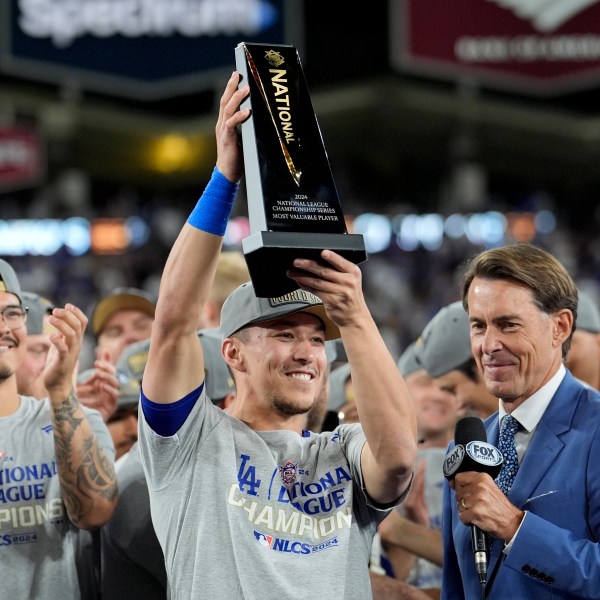 Los Angeles Dodgers' Tommy Edman celebrates after their win against the New York Mets in Game 6 of a baseball NL Championship Series, Sunday, Oct. 20, 2024, in Los Angeles. The Dodgers will face the New York Yankees in the World. (AP Photo/Ashley Landis)