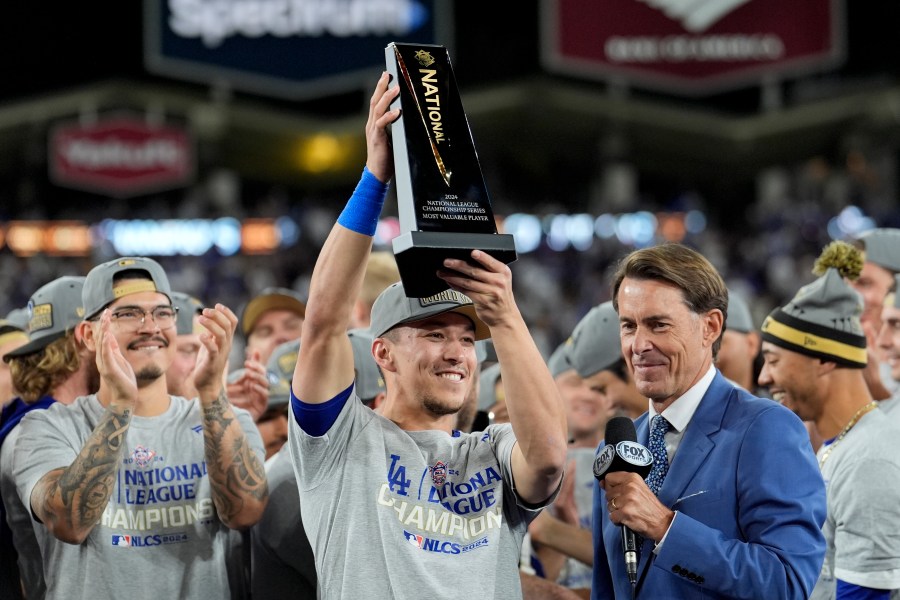 Los Angeles Dodgers' Tommy Edman celebrates after their win against the New York Mets in Game 6 of a baseball NL Championship Series, Sunday, Oct. 20, 2024, in Los Angeles. The Dodgers will face the New York Yankees in the World. (AP Photo/Ashley Landis)