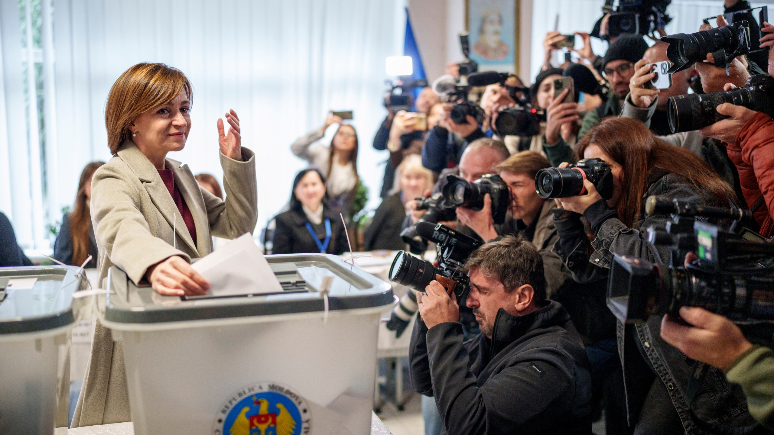 Moldova's President Maia Sandu prepares to cast her vote, in Chisinau, Moldova, Sunday, Oct. 20, 2024, during a presidential election and a referendum on whether to enshrine in the Constitution the country's path to European Union membership. (AP Photo/Vadim Ghirda)