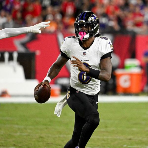 Baltimore Ravens quarterback Lamar Jackson is pressured by Tampa Bay Buccaneers linebacker Joe Tryon-Shoyinka (9) during the first half of an NFL football game, Monday, Oct. 21, 2024, in Tampa, Fla. (AP Photo/Jason Behnken)