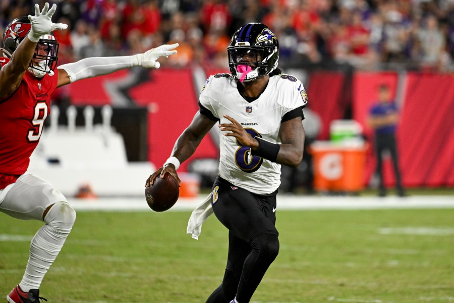 Baltimore Ravens quarterback Lamar Jackson is pressured by Tampa Bay Buccaneers linebacker Joe Tryon-Shoyinka (9) during the first half of an NFL football game, Monday, Oct. 21, 2024, in Tampa, Fla. (AP Photo/Jason Behnken)