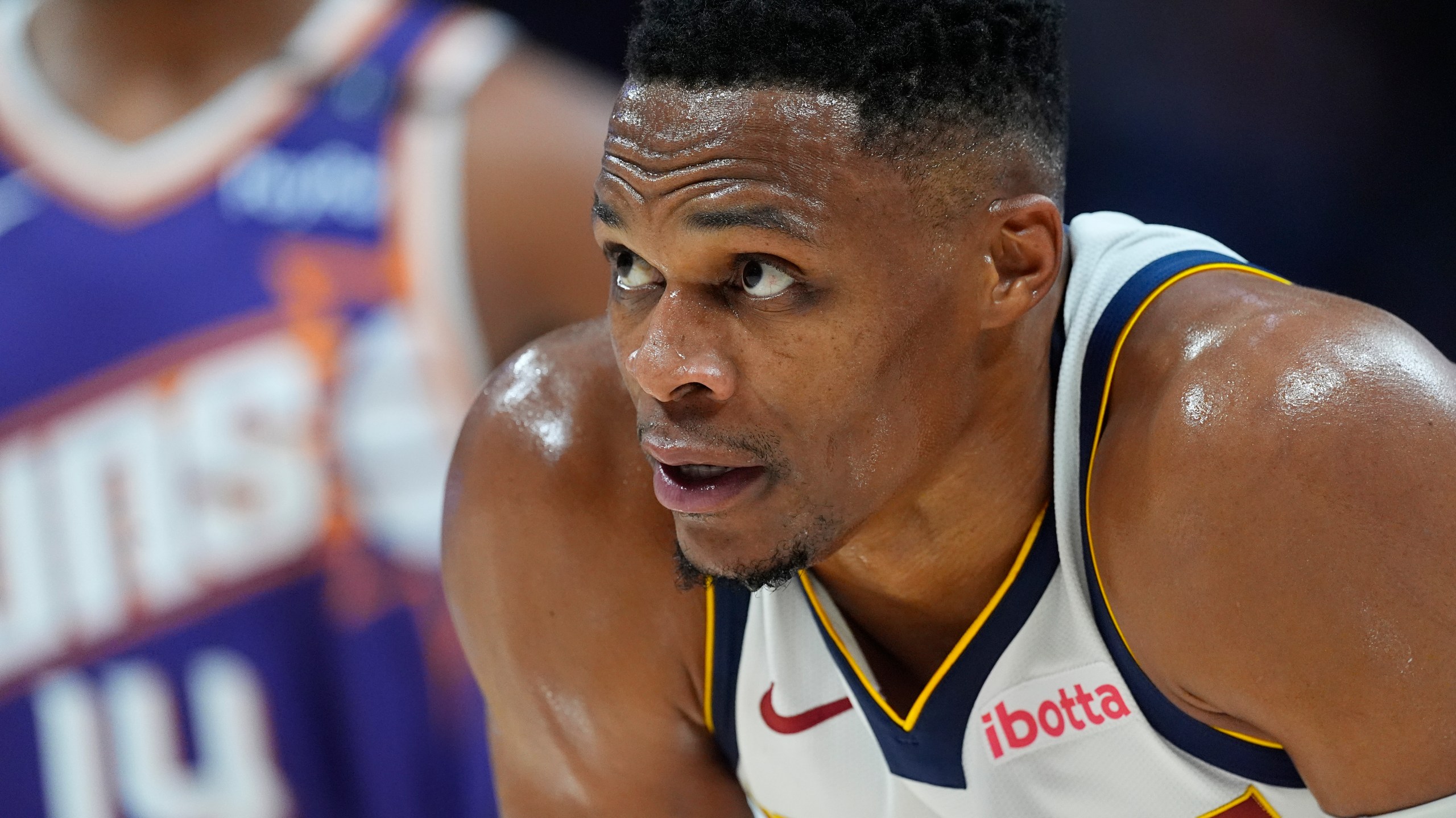 Denver Nuggets guard Russell Westbrook waits for play to resume in the second half of an NBA preseason game against the Phoenix Suns, Sunday, Oct. 13, 2024, in Denver. (AP Photo/David Zalubowski)