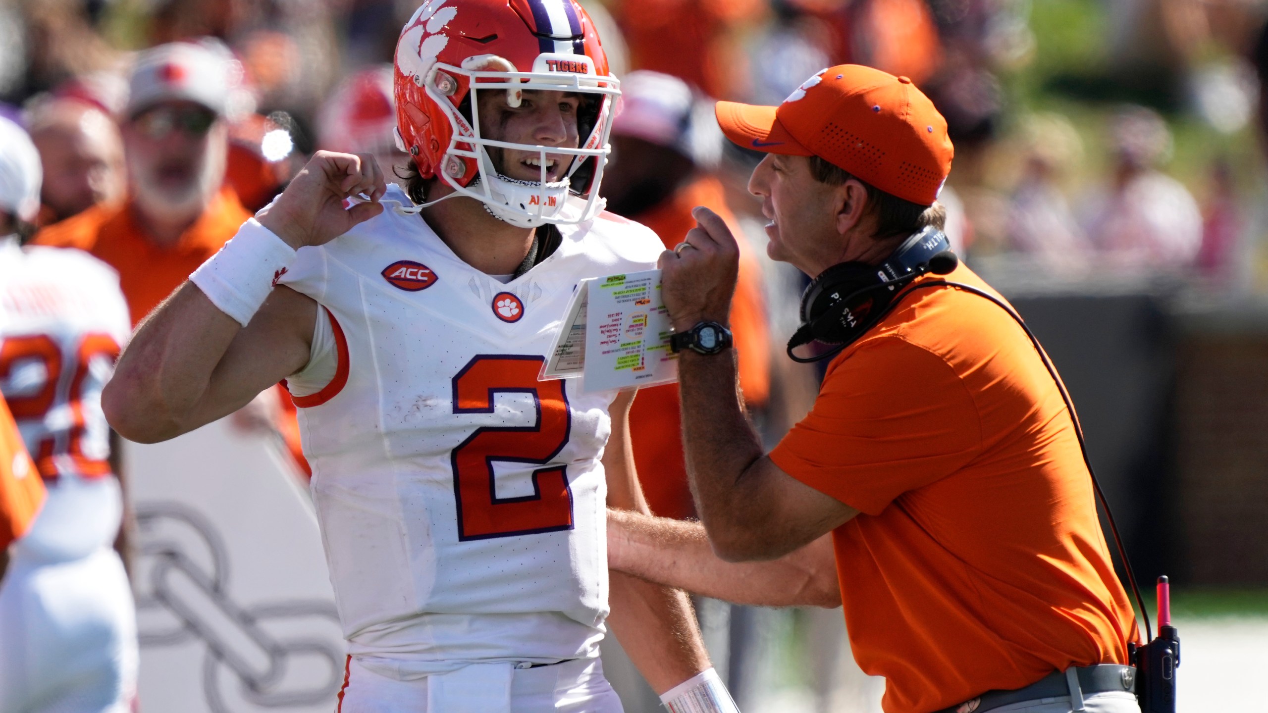 Clemson head coach Dabo Swinney, right, talks with quarterback Cade Klubnik (2) during the first half of an NCAA football game against Wake Forest in Greensboro, N.C., Saturday, Oct. 12, 2024. (AP Photo/Chuck Burton)