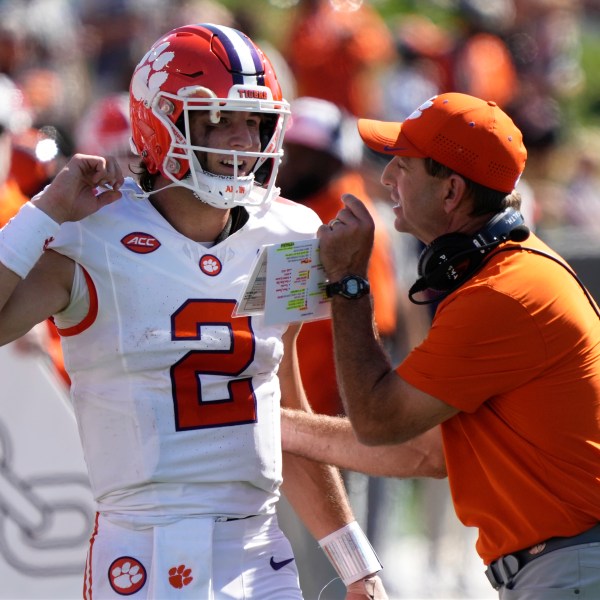 Clemson head coach Dabo Swinney, right, talks with quarterback Cade Klubnik (2) during the first half of an NCAA football game against Wake Forest in Greensboro, N.C., Saturday, Oct. 12, 2024. (AP Photo/Chuck Burton)