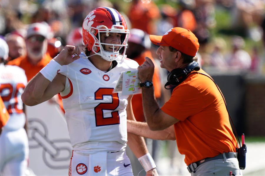 Clemson head coach Dabo Swinney, right, talks with quarterback Cade Klubnik (2) during the first half of an NCAA football game against Wake Forest in Greensboro, N.C., Saturday, Oct. 12, 2024. (AP Photo/Chuck Burton)