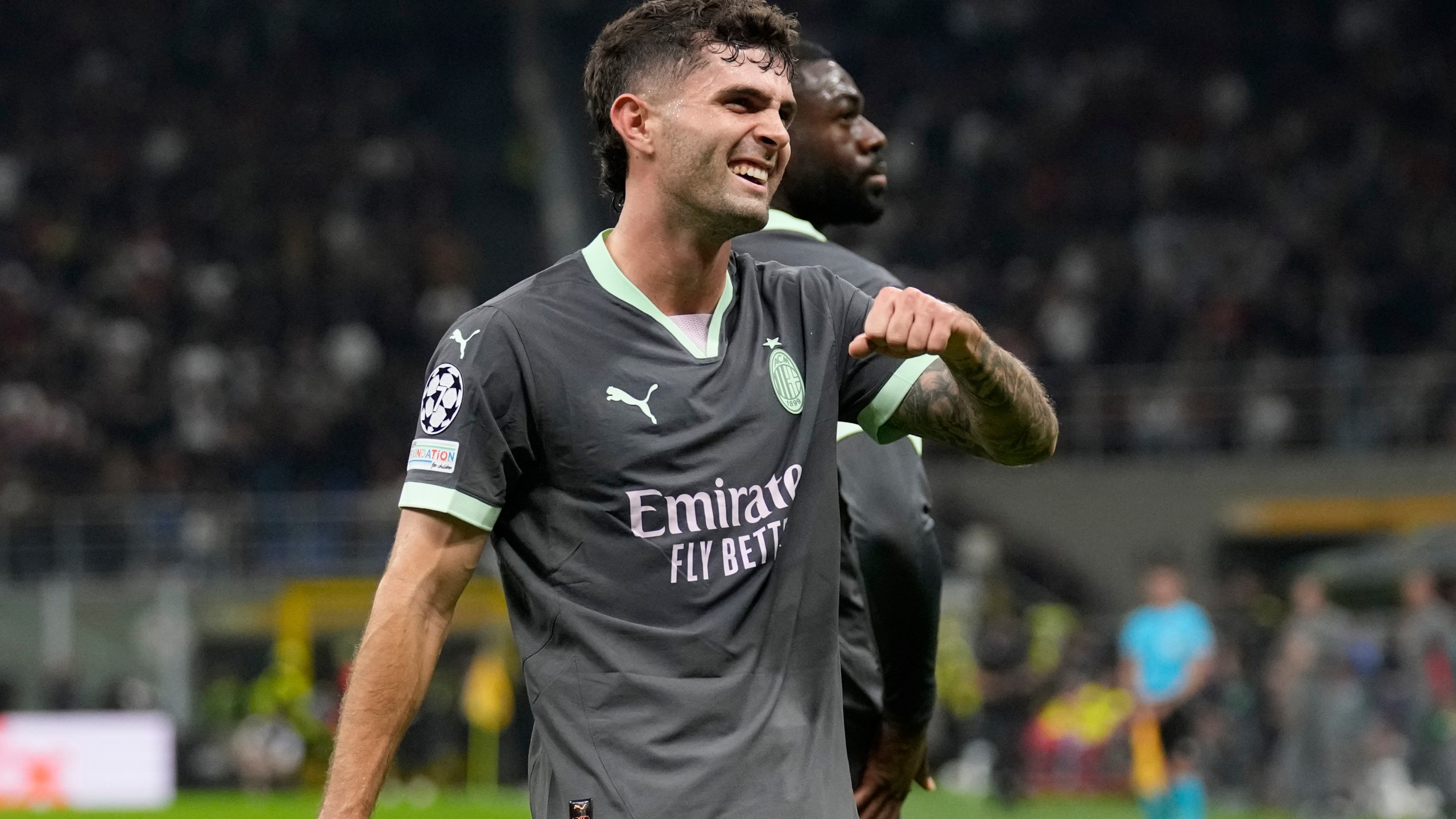 AC Milan's Christian Pulisic reacts after scoring the opening goal of his team during the Champions League opening phase soccer match between AC Milan and Club Brugge at the San Siro stadium in Milan, Italy, Tuesday, Oct. 22, 2024. (AP Photo/Antonio Calani)