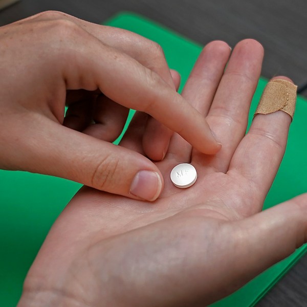 FILE - A patient prepares to take the first of two combination pills, mifepristone, for a medication abortion during a visit to a clinic in Kansas City, Kan., on, Oct. 12, 2022. (AP Photo/Charlie Riedel, File)