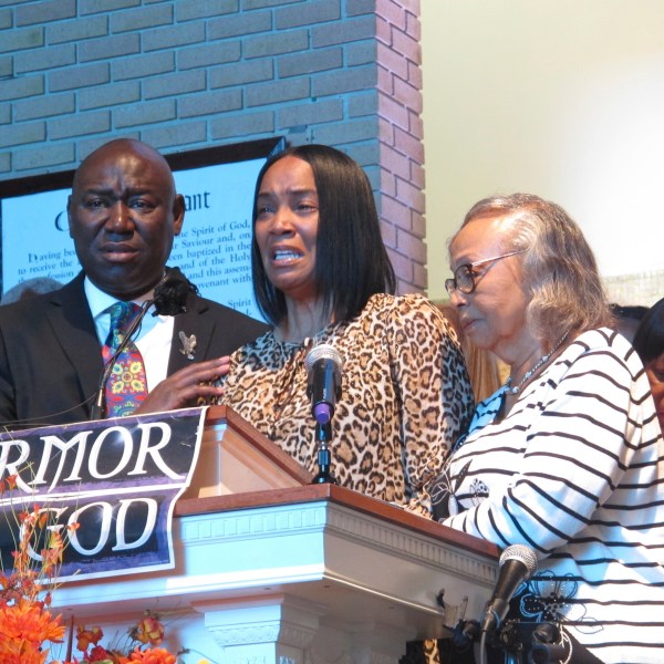 Regina Brinson, center, weeps at a news conference Tuesday, Oct. 22, 2024, while speaking alongside her mother, Katrena Alexander and attorney Ben Crump during a news conference in Jacksonville, Fla. Crump represents families of three of the seven people killed when a ferry dock walkway collapsed on Sapelo Island, Ga., on Saturday, Oct. 19. (AP Photo/Russ Bynum)