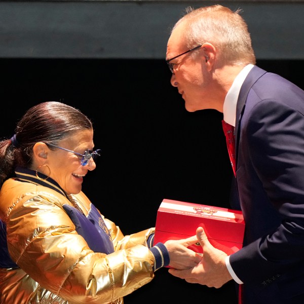 Florida Panthers head coach coach Paul Maurice, right, receives his Stanley Cup championship ring from Teresa Viola, wife of owner Vincent Viola, during a private ceremony commemorating the NHL team's Stanley Cup title last season, Monday, Oct. 7, 2024, in Fort Lauderdale, Fla. (AP Photo/Wilfredo Lee)