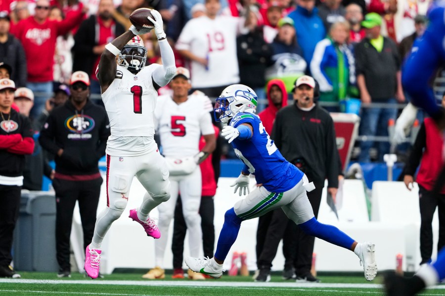 San Francisco 49ers wide receiver Deebo Samuel Sr. (1) makes a catch against Seattle Seahawks safety Julian Love, right, and would run it in for a touchdown during the first half of an NFL football game, Thursday, Oct. 10, 2024 in Seattle. (AP Photo/Lindsey Wasson)