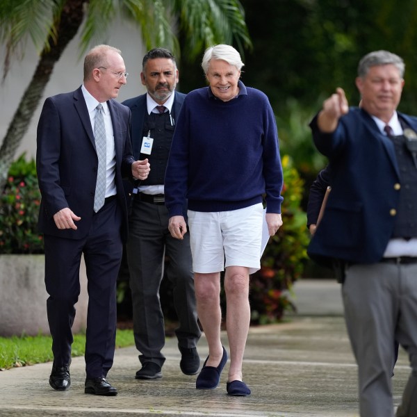 Michael Jeffries, center, former CEO of Abercrombie & Fitch, leaves with his attorney Brian Bieber, left, following a hearing at the Paul G. Rogers Federal Building and U.S. Courthouse in West Palm Beach, Fla., Tuesday, Oct. 22, 2024. (AP Photo/Rebecca Blackwell)