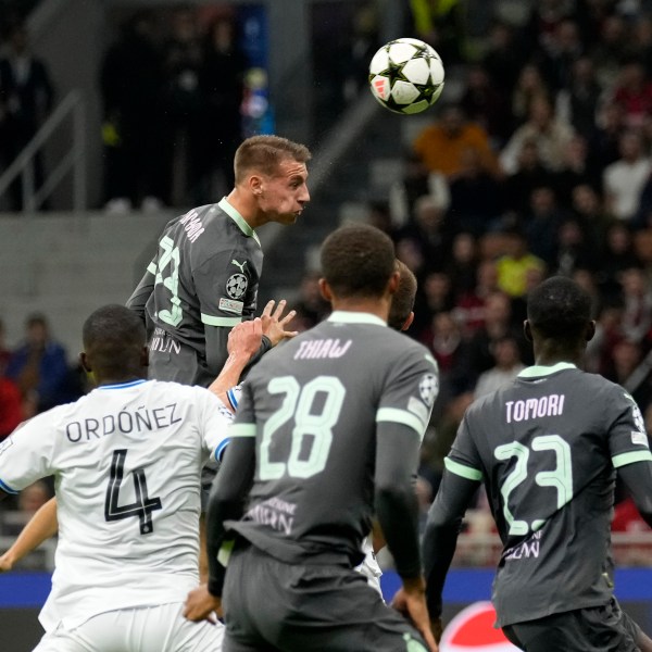 AC Milan's Francesco Camarda heads the ball to score a disallowed goal during the Champions League opening phase soccer match between AC Milan and Club Brugge at the San Siro stadium in Milan, Italy, Tuesday, Oct. 22, 2024. (AP Photo/Antonio Calani)