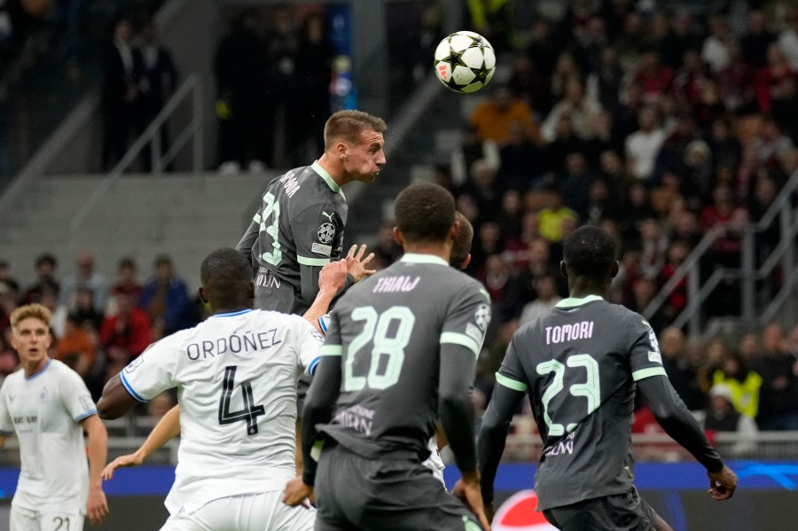 AC Milan's Francesco Camarda heads the ball to score a disallowed goal during the Champions League opening phase soccer match between AC Milan and Club Brugge at the San Siro stadium in Milan, Italy, Tuesday, Oct. 22, 2024. (AP Photo/Antonio Calani)