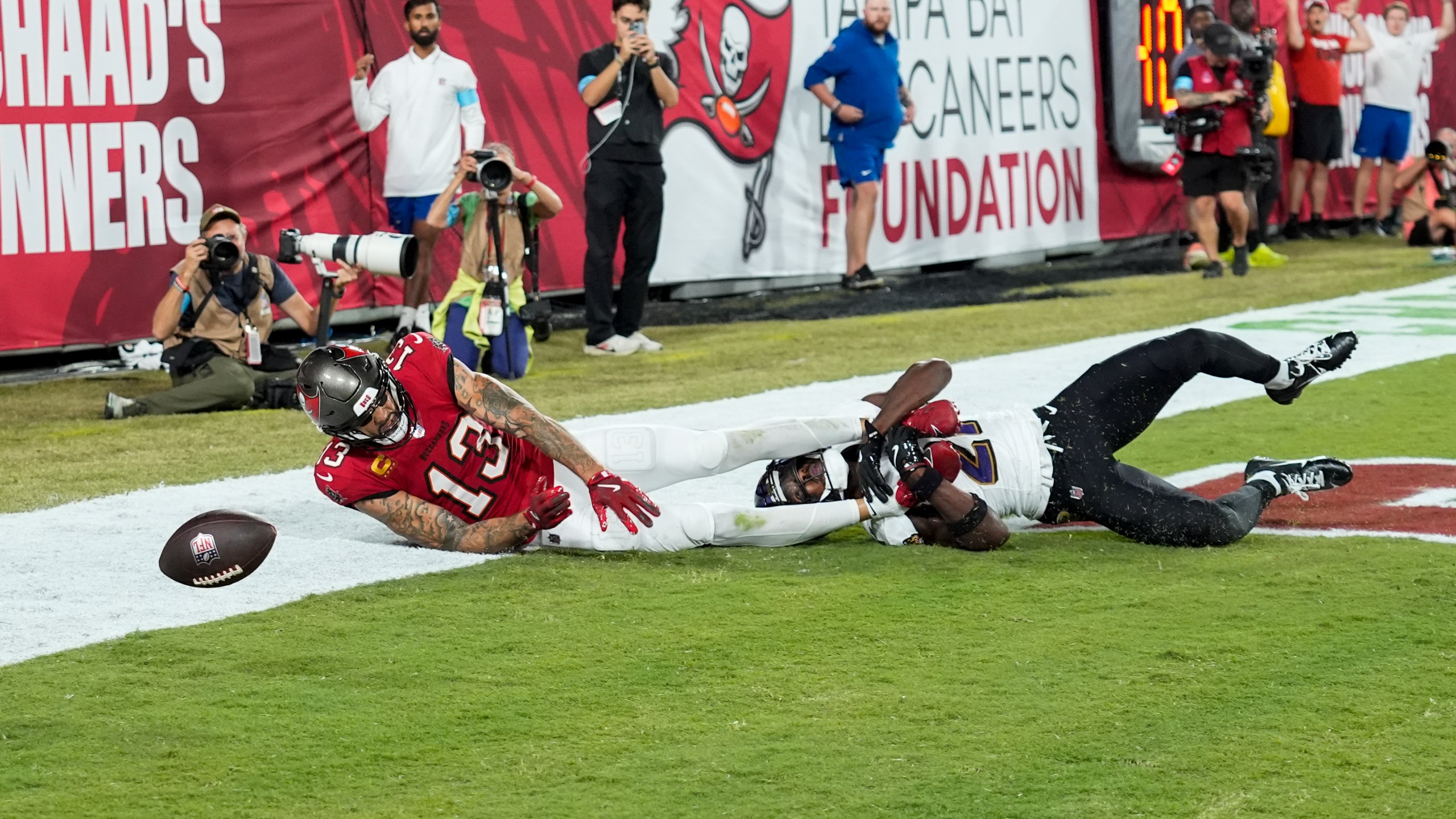 Baltimore Ravens cornerback Brandon Stephens (21) breaks up a pass intended for Tampa Bay Buccaneers wide receiver Mike Evans (13) during the first half of an NFL football game, Monday, Oct. 21, 2024, in Tampa, Fla. (AP Photo/Chris O'Meara)