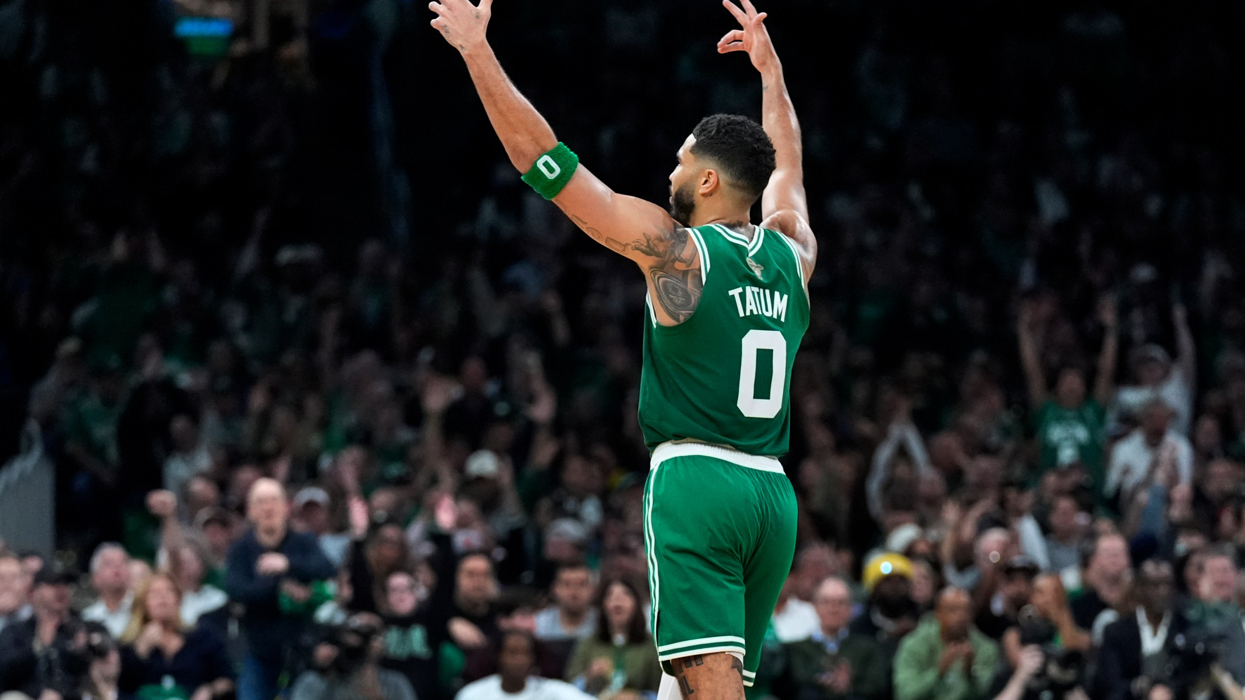 Boston Celtics forward Jayson Tatum (0) celebrates after a 3-pointer during the second half of an NBA basketball game against the New York Knicks, Tuesday, Oct. 22, 2024, in Boston. (AP Photo/Charles Krupa)