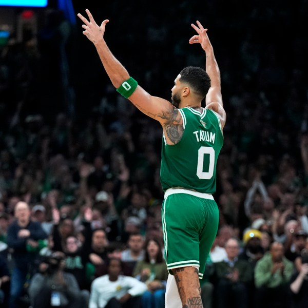 Boston Celtics forward Jayson Tatum (0) celebrates after a 3-pointer during the second half of an NBA basketball game against the New York Knicks, Tuesday, Oct. 22, 2024, in Boston. (AP Photo/Charles Krupa)