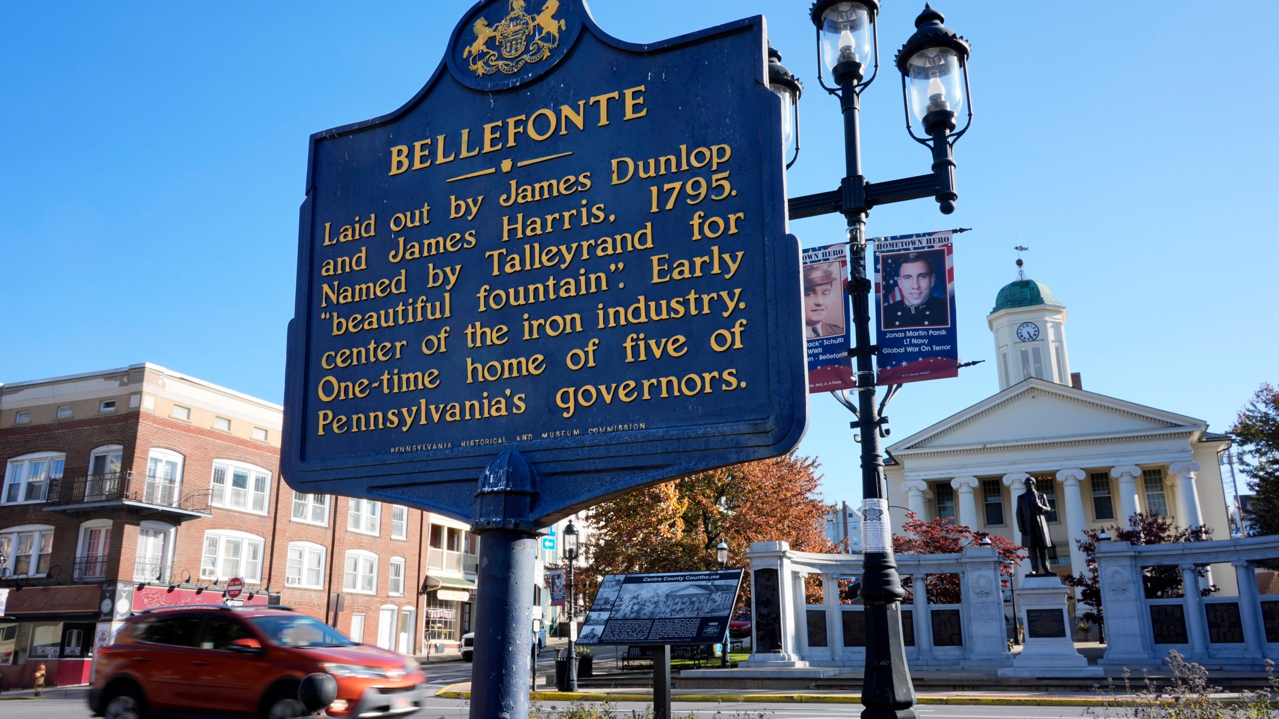 A historical marker stands in downtown Bellefonte, Pa., near the Centre County Courthouse, rear right, Friday, Oct. 18, 2024. (AP Photo/Gene J. Puskar)