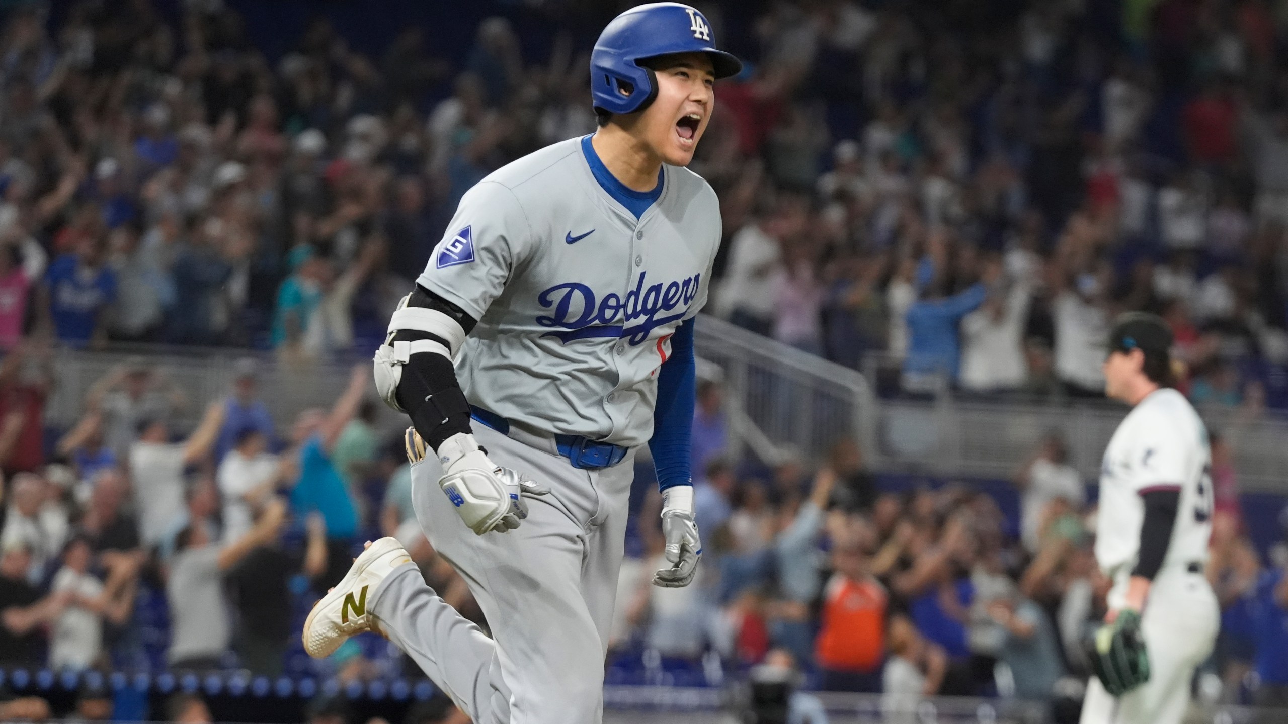 Los Angeles Dodgers' Shohei Ohtani (17) reacts after hitting his 50th home run of the season during the seventh inning of a baseball game against the Miami Marlins, Thursday, Sept. 19, 2024, in Miami. (AP Photo/Marta Lavandier)