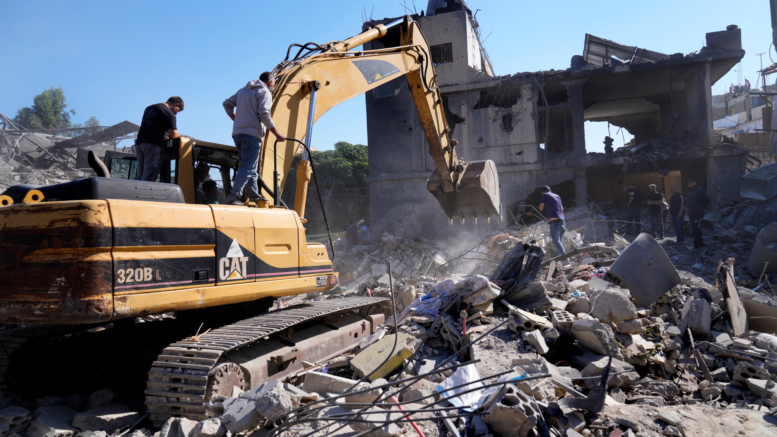 A bulldozer clears the rubble of destroyed buildings following Israeli airstrikes in a densely-populated neighbourhood facing the city's main government hospital, in southern Beirut, Lebanon, Tuesday, Oct. 22, 2024. (AP Photo/Hussein Malla)