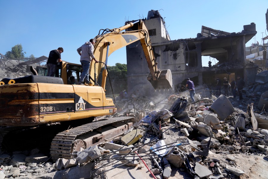 A bulldozer clears the rubble of destroyed buildings following Israeli airstrikes in a densely-populated neighbourhood facing the city's main government hospital, in southern Beirut, Lebanon, Tuesday, Oct. 22, 2024. (AP Photo/Hussein Malla)