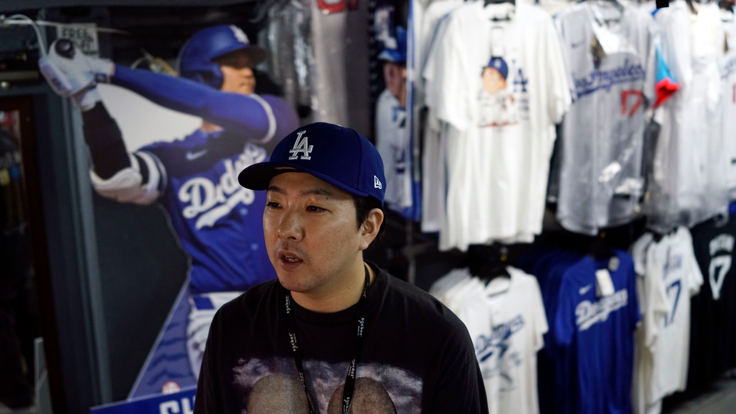 Store manager Takeru Watanabe speaks in front of goods related to Shohei Ohtani of the Los Angeles Dodgers at a sporting goods store, "SELECTION," in Shinjuku district Wednesday, Oct. 23, 2024 in Tokyo. (AP Photo/Eugene Hoshiko)