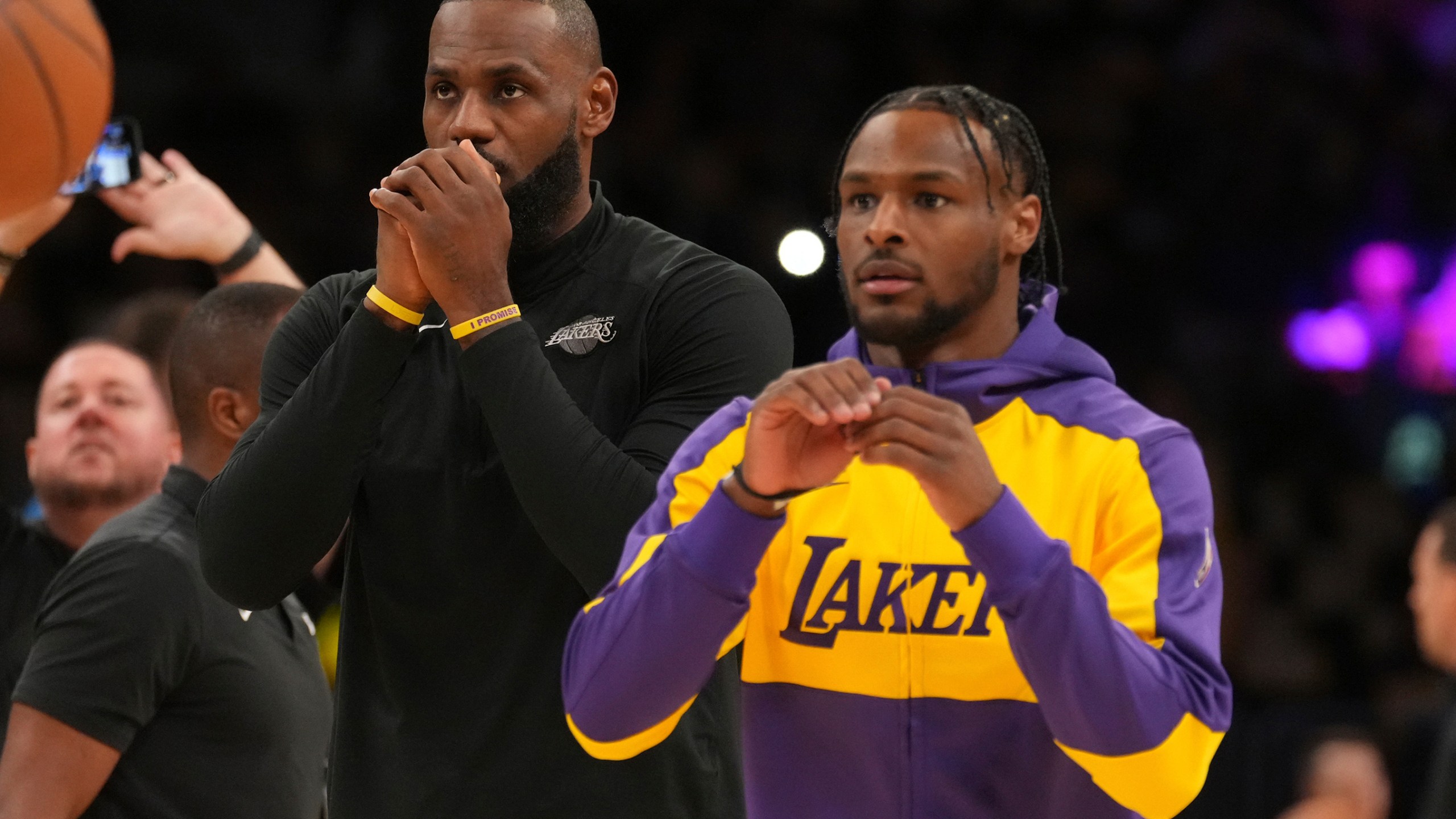 Los Angeles Lakers forward LeBron James, left, and guard Bronny James warm up before an NBA basketball game against the Minnesota Timberwolves, Tuesday, Oct. 22, 2024, in Los Angeles. (AP Photo/Eric Thayer)