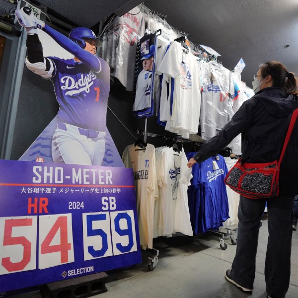 Customers shop around for goods related to Shohei Ohtani of the Los Angeles Dodgers at a sporting goods store, "SELECTION," in Shinjuku district Wednesday, Oct. 23, 2024 in Tokyo. (AP Photo/Eugene Hoshiko)