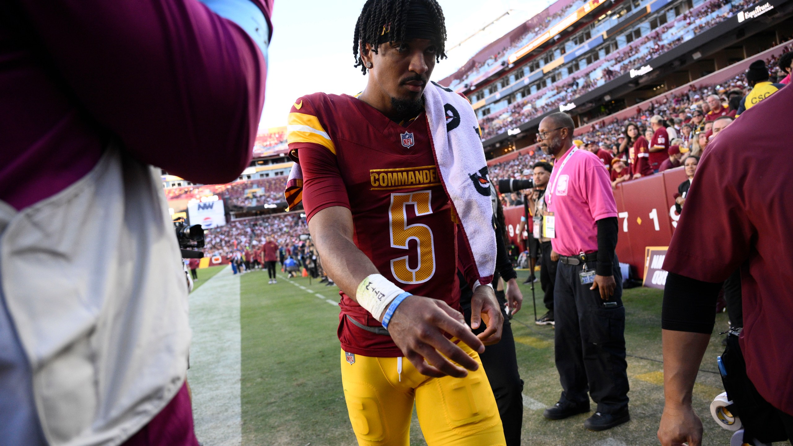 Washington Commanders quarterback Jayden Daniels walks off the field after getting injured during the first half of an NFL football game against the Carolina Panthers, Sunday, Oct. 20, 2024, in Landover, Md. (AP Photo/Nick Wass)