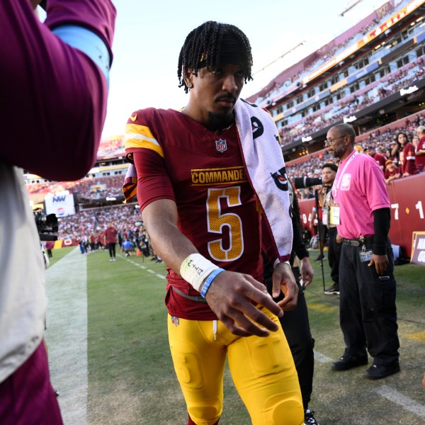 Washington Commanders quarterback Jayden Daniels walks off the field after getting injured during the first half of an NFL football game against the Carolina Panthers, Sunday, Oct. 20, 2024, in Landover, Md. (AP Photo/Nick Wass)