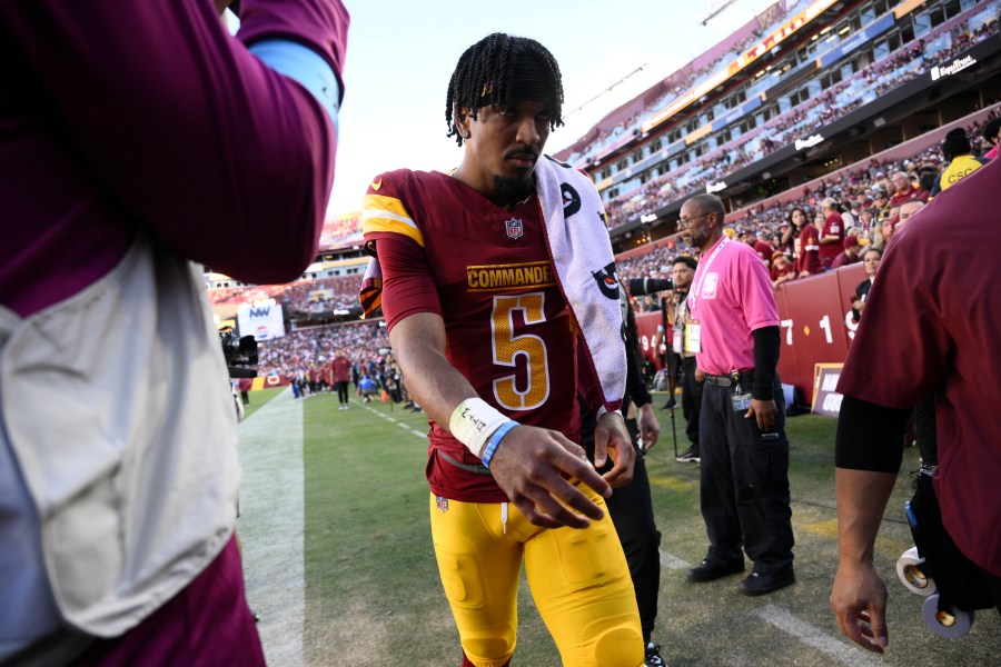 Washington Commanders quarterback Jayden Daniels walks off the field after getting injured during the first half of an NFL football game against the Carolina Panthers, Sunday, Oct. 20, 2024, in Landover, Md. (AP Photo/Nick Wass)