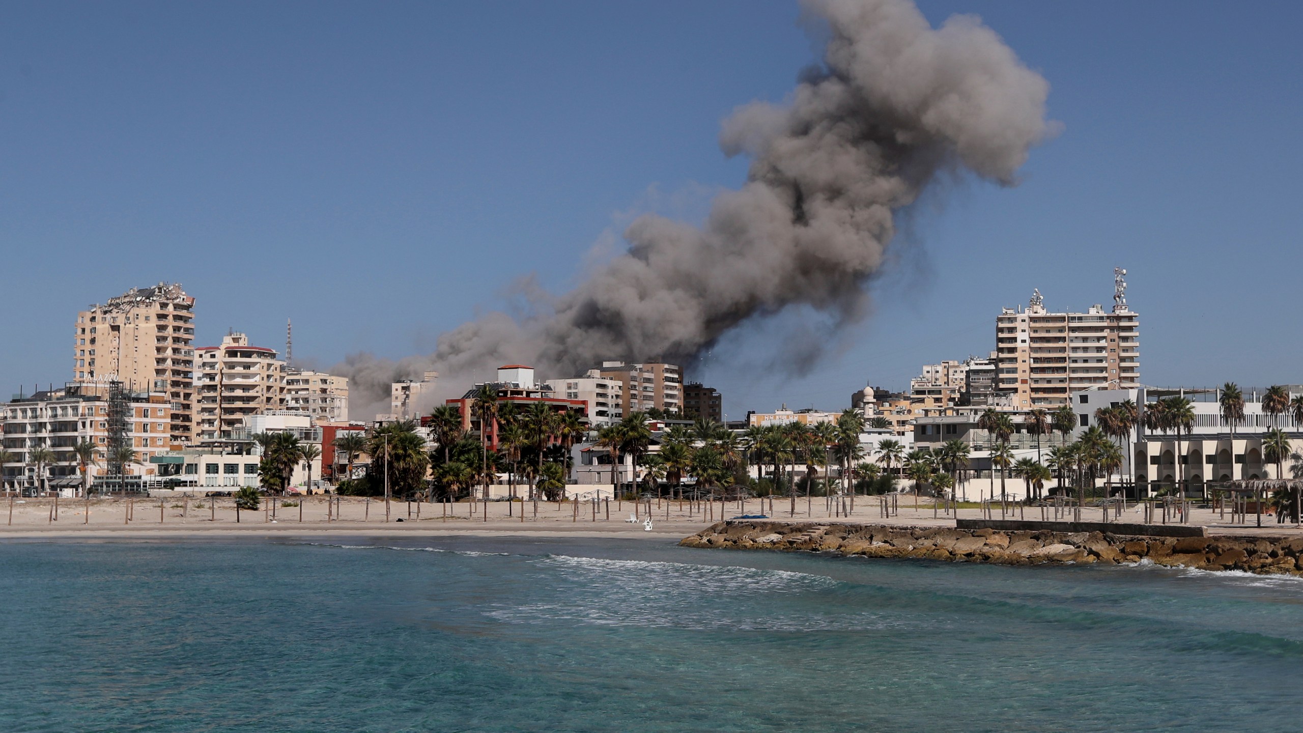 Smoke rises from buildings hit in an Israeli airstrike in Tyre, Lebanon, Wednesday, Oct. 23, 2024. (AP Photo/Mohammad Zaatari)