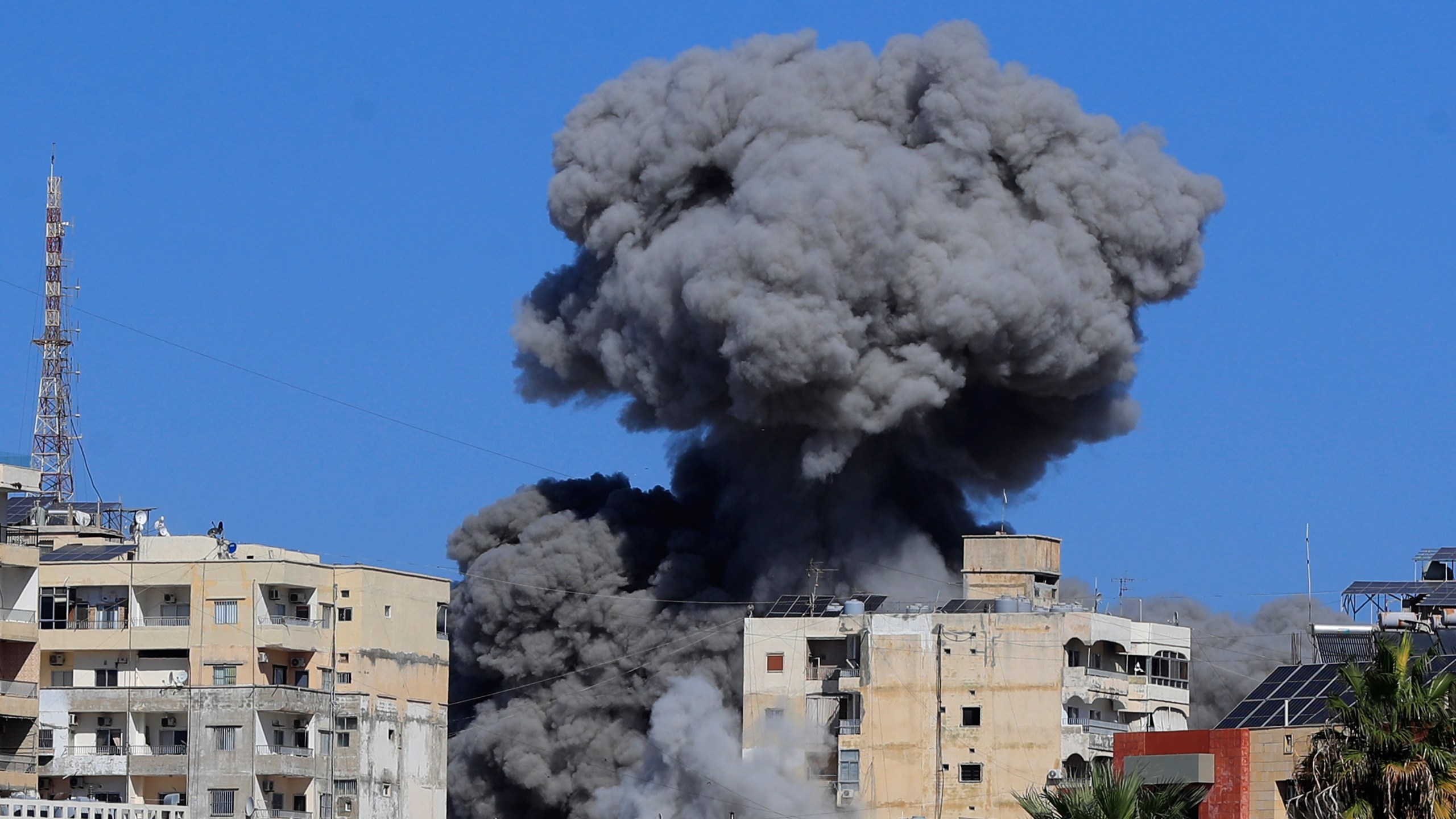 Smoke rises from buildings hit in an Israeli airstrike in Tyre, Lebanon, Wednesday, Oct. 23, 2024. (AP Photo/Mohammad Zaatari)