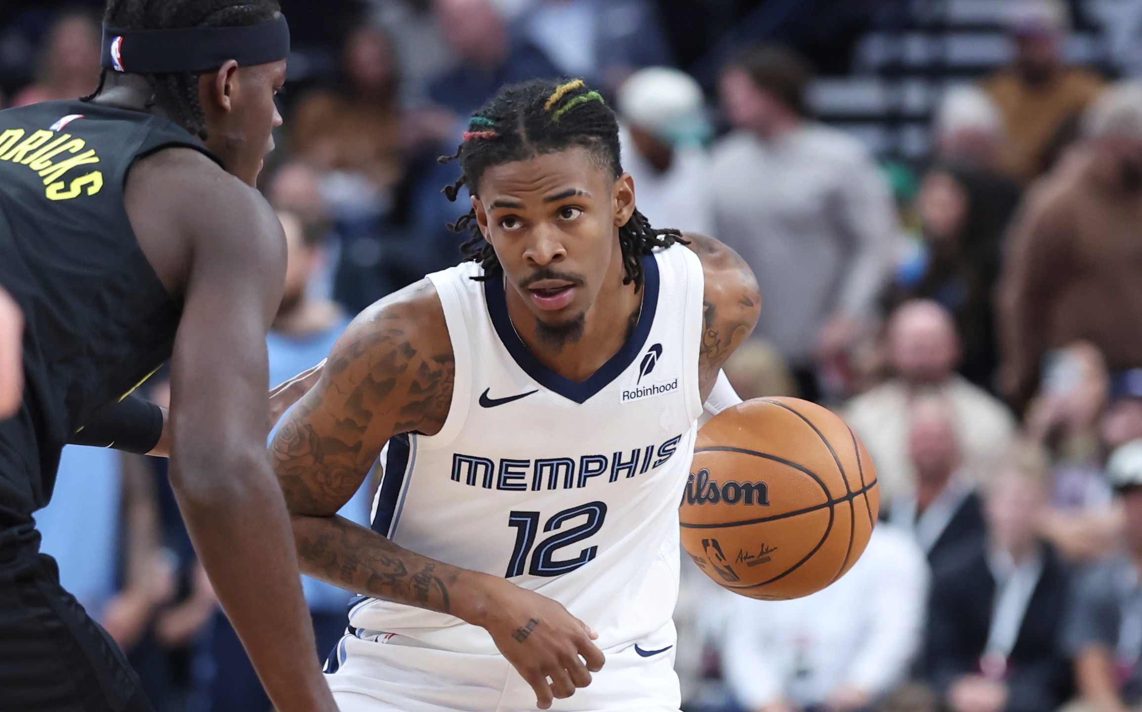 Memphis Grizzlies guard Ja Morant (12) holds the ball against the Utah Jazz during the first half of an NBA basketball game, Wednesday, Oct. 23, 2024, in Salt Lake City. (AP Photo/Rob Gray)