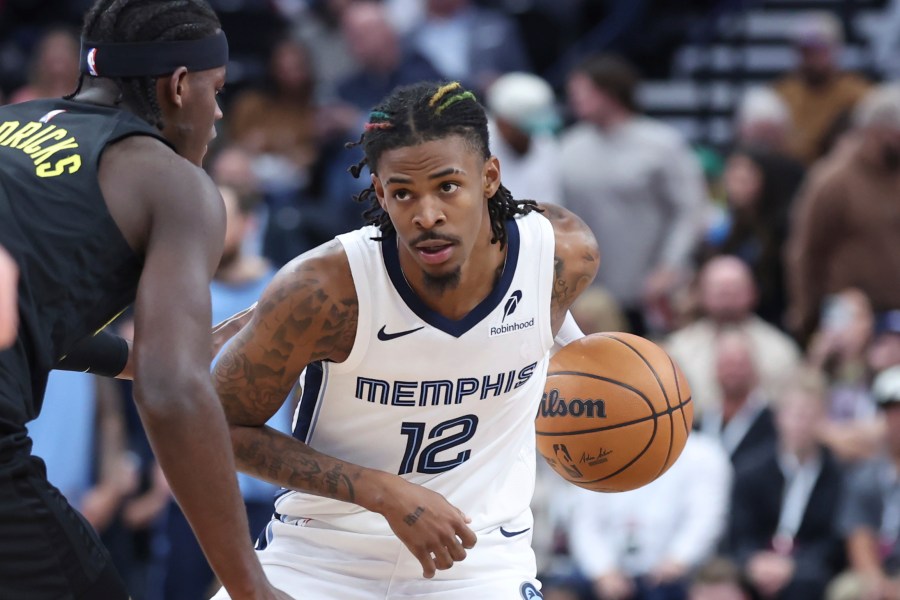 Memphis Grizzlies guard Ja Morant (12) holds the ball against the Utah Jazz during the first half of an NBA basketball game, Wednesday, Oct. 23, 2024, in Salt Lake City. (AP Photo/Rob Gray)