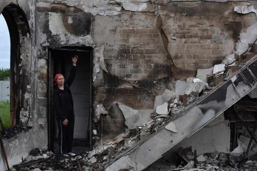 FILE - Valentina, 53, a local woman, stands inside the Evangelical Christian Baptists prayer house in Orihiv, Ukraine, on Monday, May 22, 2023, which was destroyed the previous day by a Russian attack. (AP Photo/Andriy Andriyenko, File)