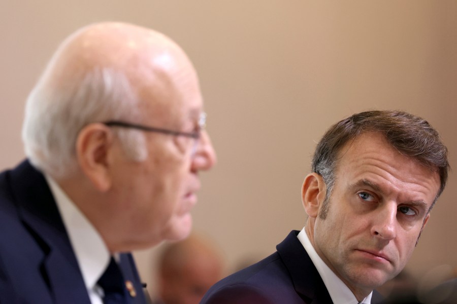 French President Emmanuel Macron listens to Lebanon's Prime Minister caretaker Prime Minister Najib Mikati, left, during international conference for Lebanon in Paris, Thursday, Oct.24, 2024. (Alain Jocard, Pool via AP)