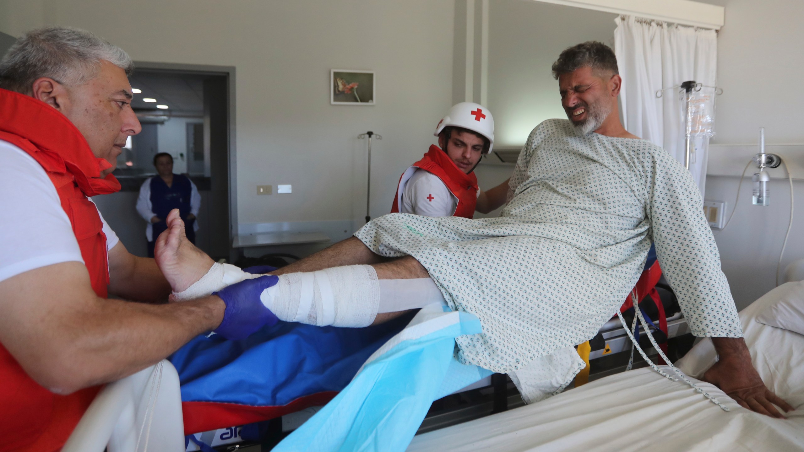 An injured cameraman is moved by the Lebanese Red Cross to a hospital, at the site where an Israeli airstrike hit a compound housing journalists, killing three media staffers from two different news agencies according to Lebanon's state-run National News Agency, in Hasbaya village, southeast Lebanon, Friday, Oct. 25, 2024. (AP Photo/Mohammed Zaatari)