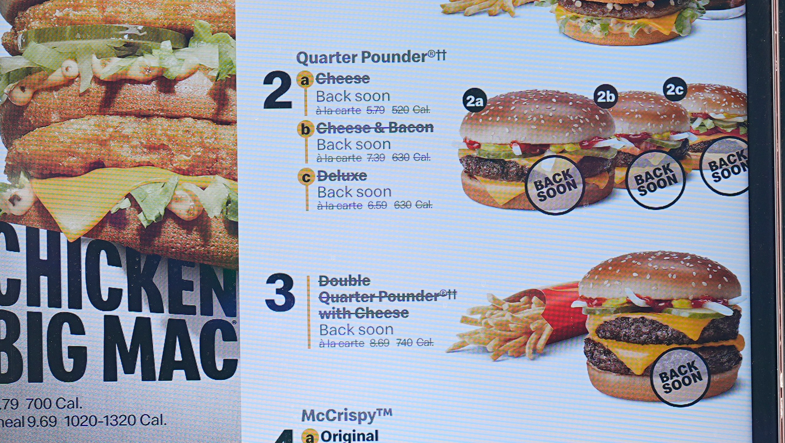 The electronic menu order board still displays Quarter Pounder hamburgers but with a prompt to tell consumers they will be available soon at a McDonald's drive-thru Wednesday, Oct. 23, 2024, in Littleton, Colo. (AP Photo/David Zalubowski)