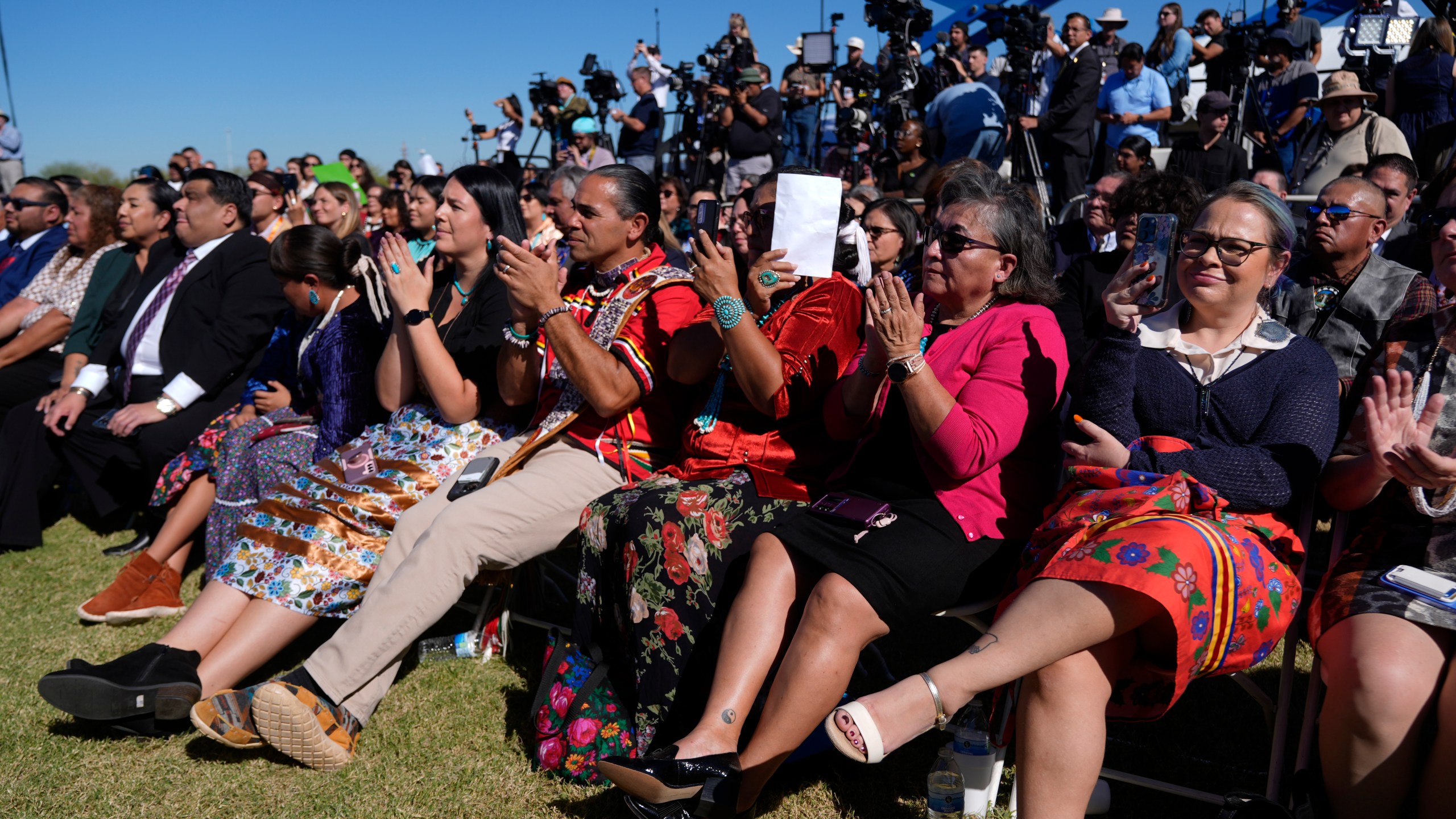 Attendees listen as Interior Secretary Deb Haaland speaks before President Joe Biden at the Gila Crossing Community School in the Gila River Indian Community reservation in Laveen, Ariz., Friday, Oct. 25, 2024. (AP Photo/Manuel Balce Ceneta)