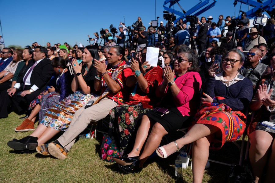 Attendees listen as Interior Secretary Deb Haaland speaks before President Joe Biden at the Gila Crossing Community School in the Gila River Indian Community reservation in Laveen, Ariz., Friday, Oct. 25, 2024. (AP Photo/Manuel Balce Ceneta)