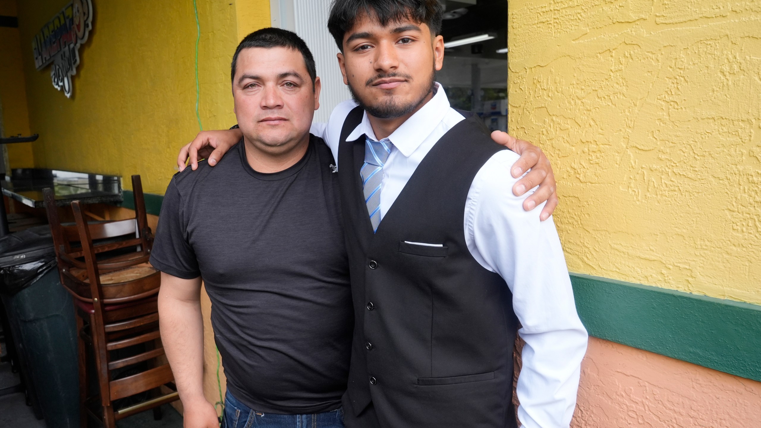 FILE - Billy and his father, no last name given, pause after speaking at a Democratic Party campaign event about their experience of being separated at the U.S.- Mexico border during the Trump administration, Oct. 16, 2024, in Doral, Fla. (AP Photo/Marta Lavandier, File)