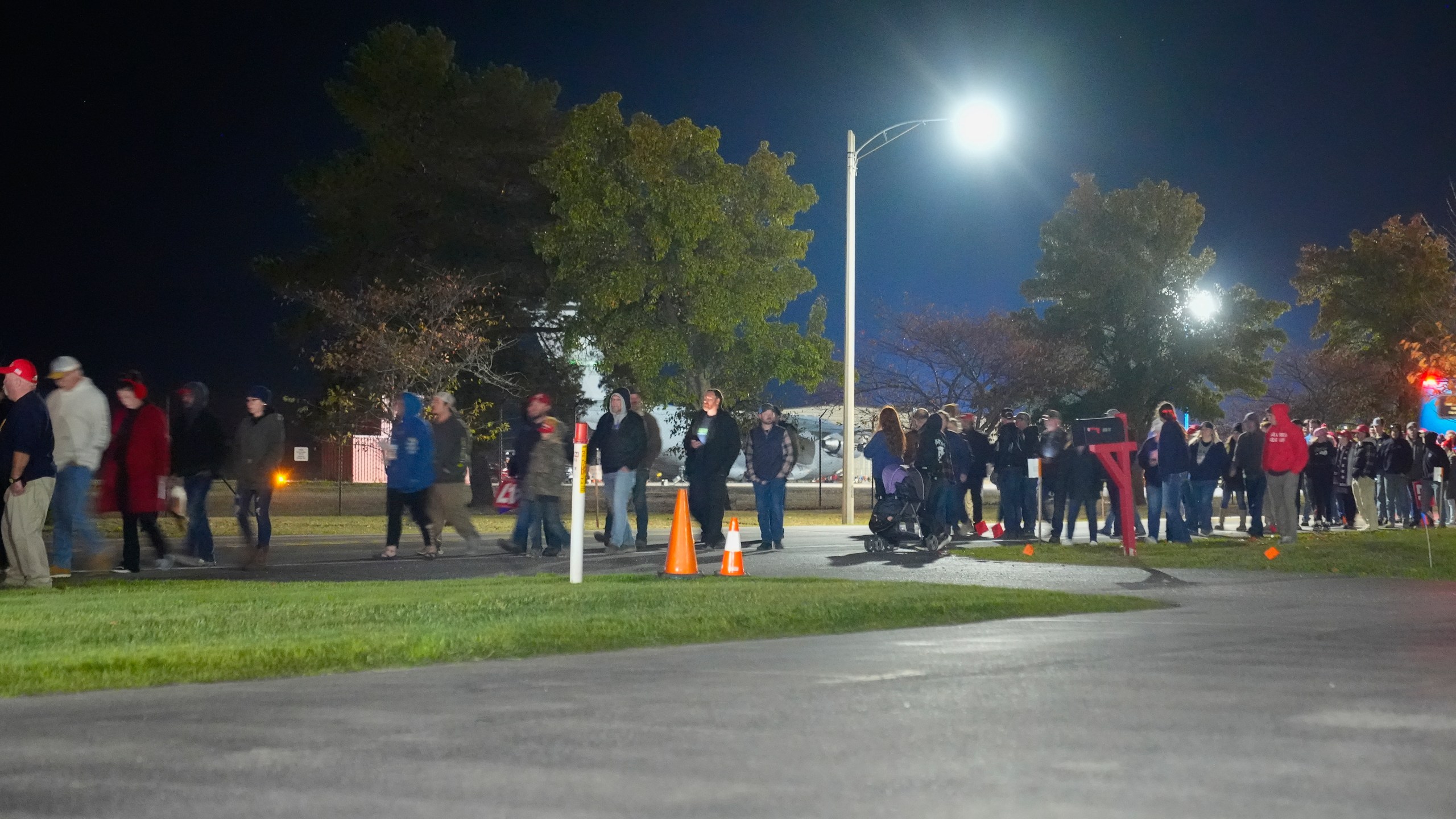 Supporters are seen leaving a campaign rally ahead of the arrival of Republican presidential nominee former President Donald Trump at Cherry Capital Airport, Friday, Oct. 25, 2024, in Traverse City, Mich. (AP Photo/Alex Brandon)