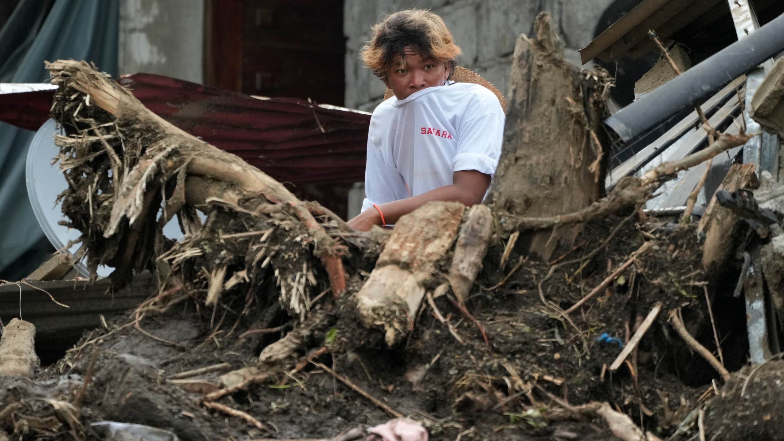 A villager watches rescue operations after a recent landslide triggered by Tropical Storm Trami struck Talisay, Batangas province, Philippines leaving thousands homeless and several villagers dead on Saturday, Oct. 26, 2024. (AP Photo/Aaron Favila)