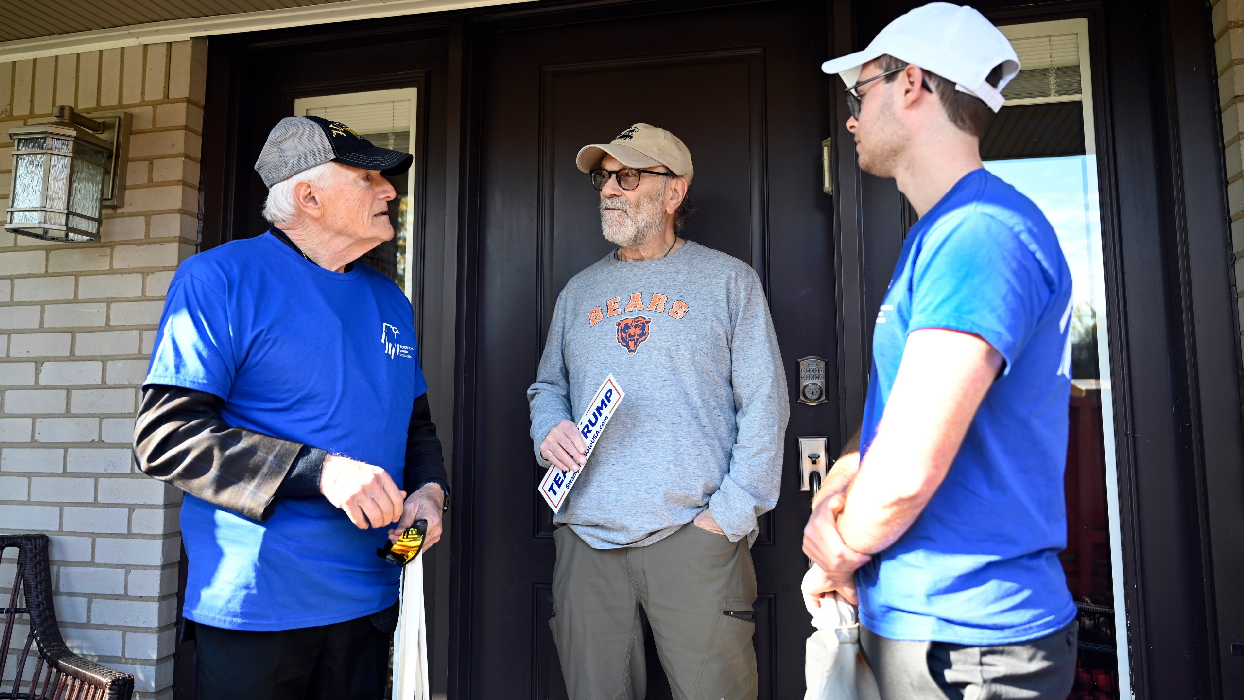 Republican Jewish Coalition members David Cuttner, left, and Noam Nedivi, right, talk with David Rabens about the election, Sunday, Oct. 27, 2024, in West Bloomfield Township, Mich. (AP Photo/Jose Juarez)