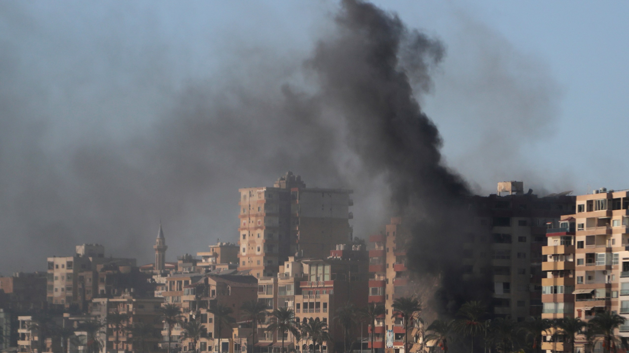 Smoke rises from a building hit in an Israeli airstrike in Tyre, southern Lebanon, Monday, Oct. 28, 2024. (AP Photo/Mohammad Zaatari)