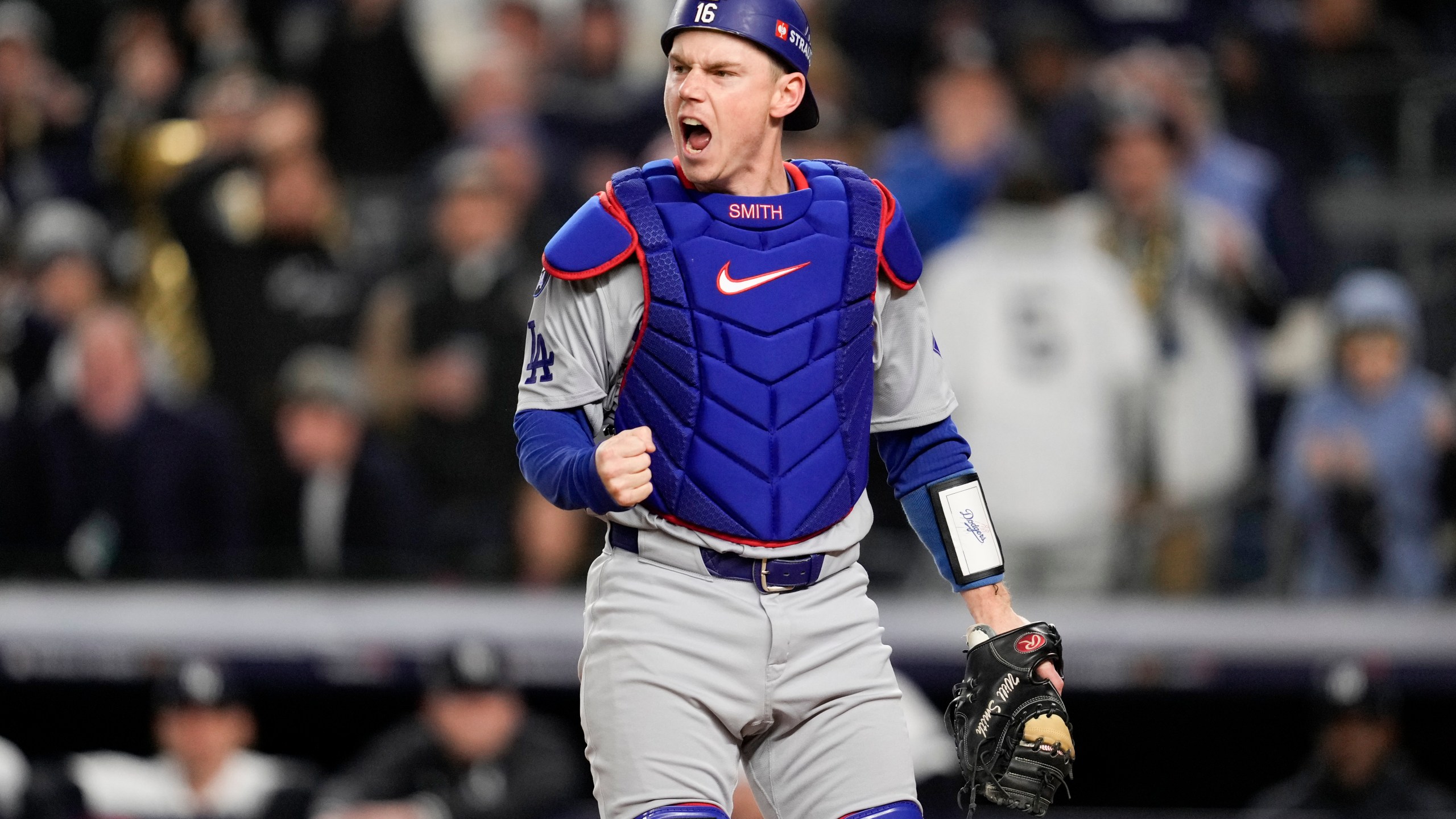 Los Angeles Dodgers catcher Will Smith celebrates after tagging New York Yankees' out at home during the fourth inning in Game 3 of the baseball World Series, Monday, Oct. 28, 2024, in New York. (AP Photo/Ashley Landis)